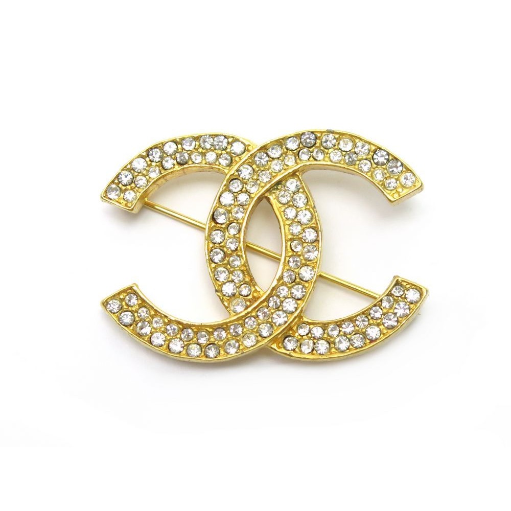 broche chanel logo cc en metal dore et strass