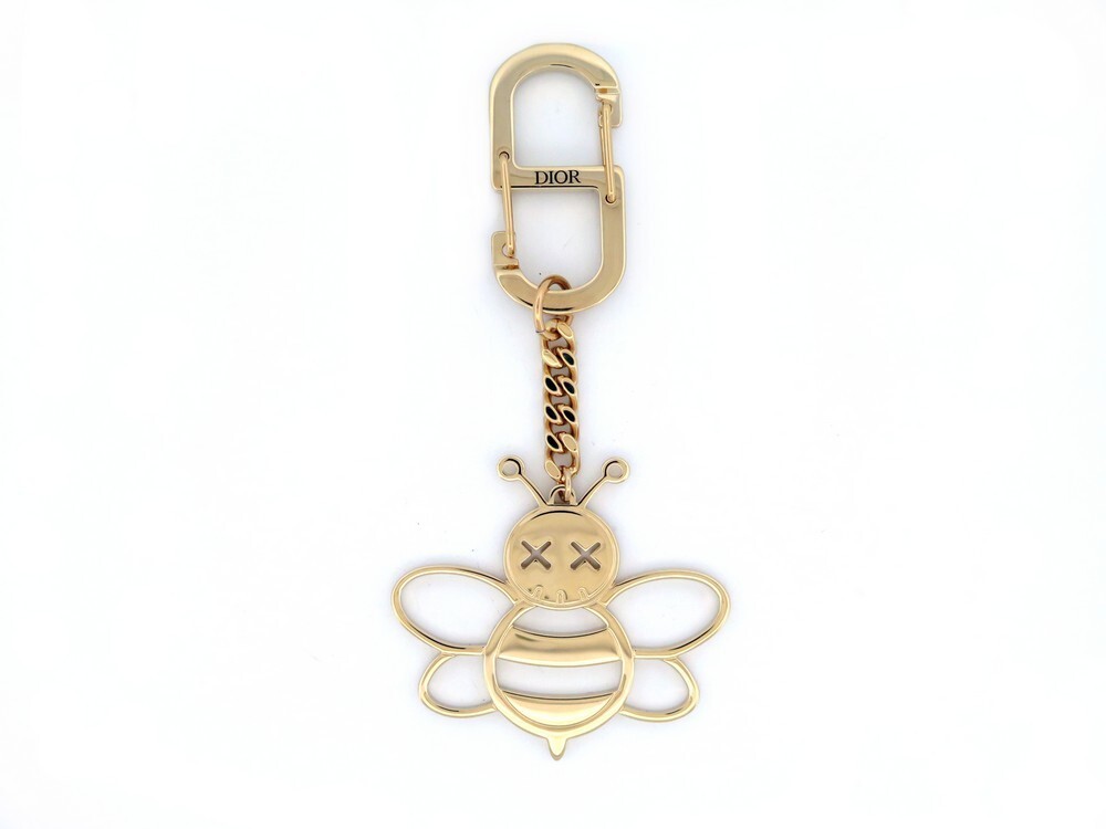 porte cle christian dior x kaws bee en metal dore